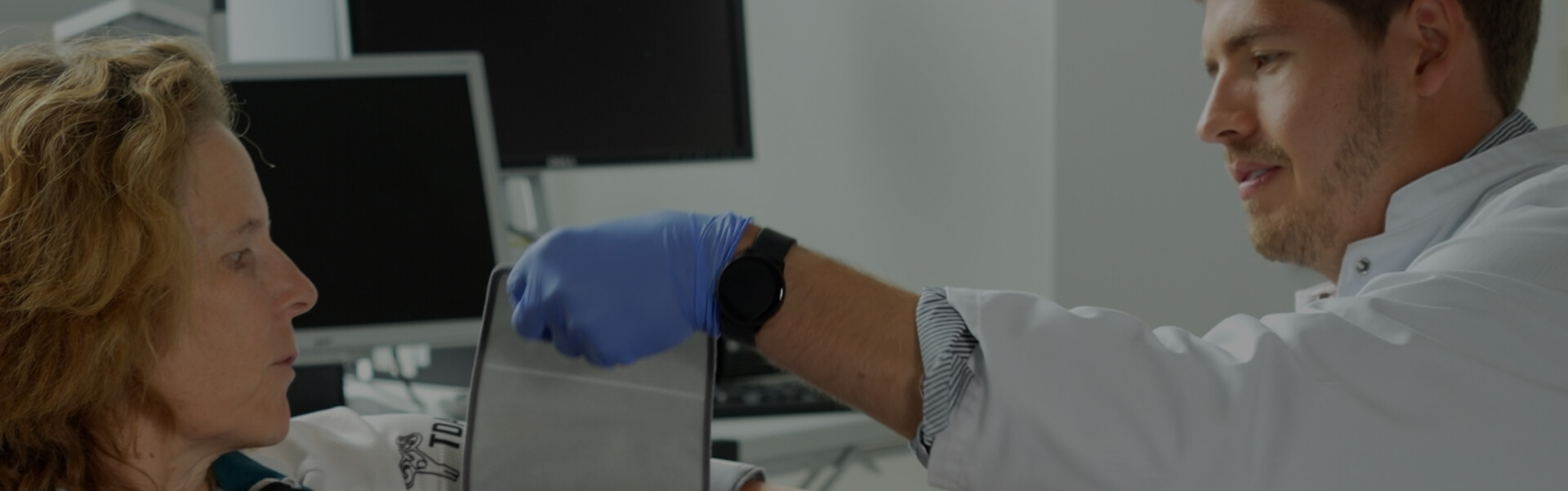 Medical professional assisting a woman during a clinical study session